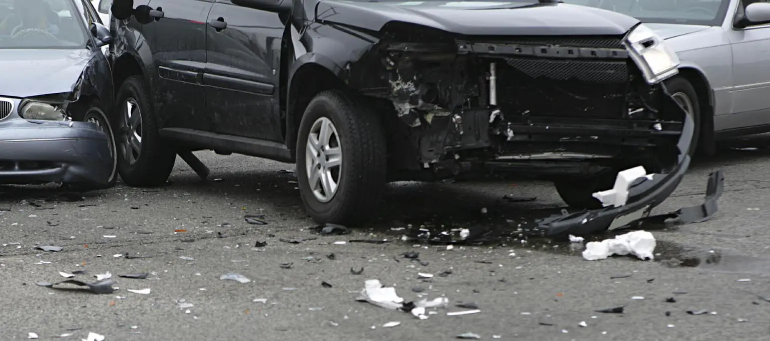 Multi-vehicle accident showing 3 of the vehicles involved, an SUV with extensive front-end damage and one car on each side that has collided with the SUV. An experienced multi-vehicle accident lawyer will know how to determine fault in such accidents and how to help you obtain the maximum fair compensation from insurance and other sources.