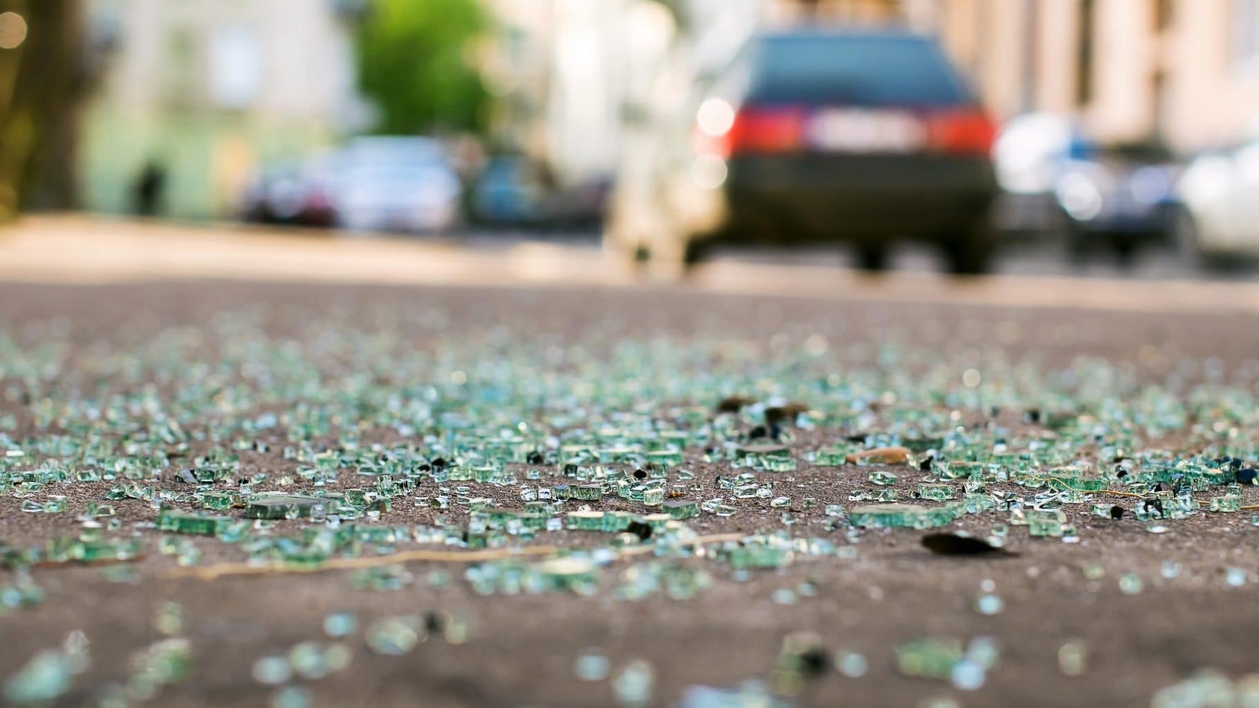 Glass on street as drunk driver leaves the scene of the accident. Victims of drunk driver accidents should protect themselves by contacting a personal injury lawyer experienced in handling drunk driver accidents.