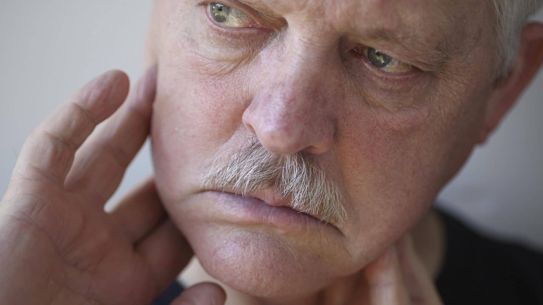 Photo of a man who may have a TMJ injury.'In Alberta, TMJ Dysfunction (a type of TMJ injury) is not subject to the Minor Injury Regulations if the TMJ involves damage to the bone or teeth or damage to or displacement of the articular disc,' Joseph Nagy, Edmonton Injury Lawyer.